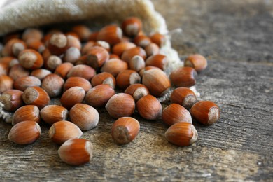 Tasty hazelnuts on wooden table, closeup. Healthy snack