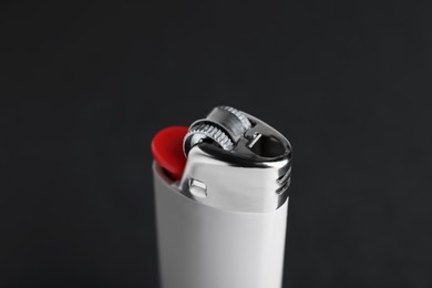 Photo of Stylish small pocket lighter on black background, closeup