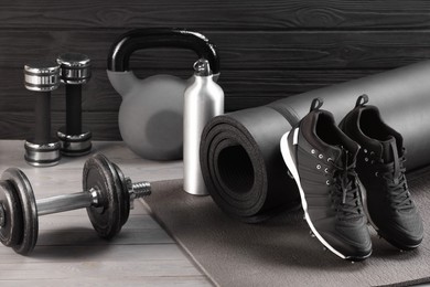 Photo of Many different sports equipment on grey wooden table