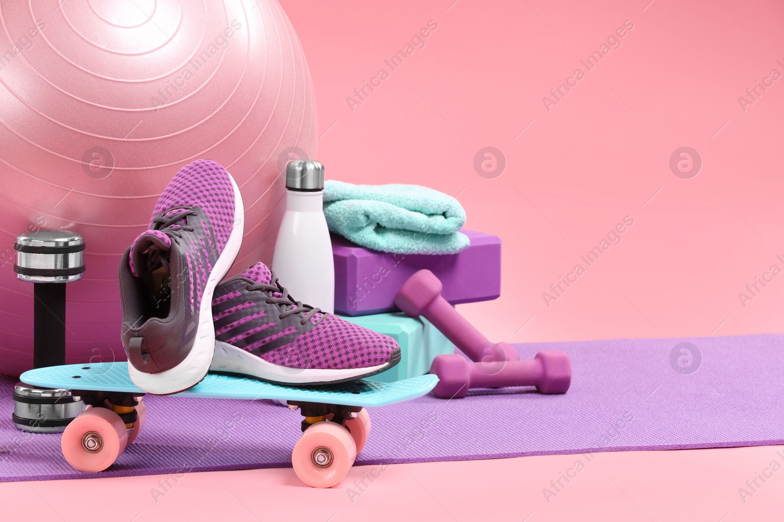 Photo of Many different sports equipment on pink background, space for text