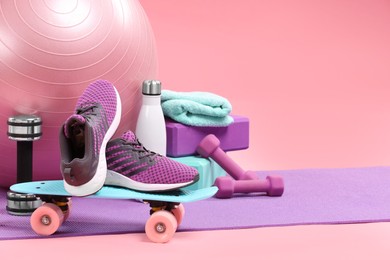 Many different sports equipment on pink background, space for text