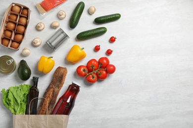 Fresh vegetables and other products on light grey background, flat lay. Space for text