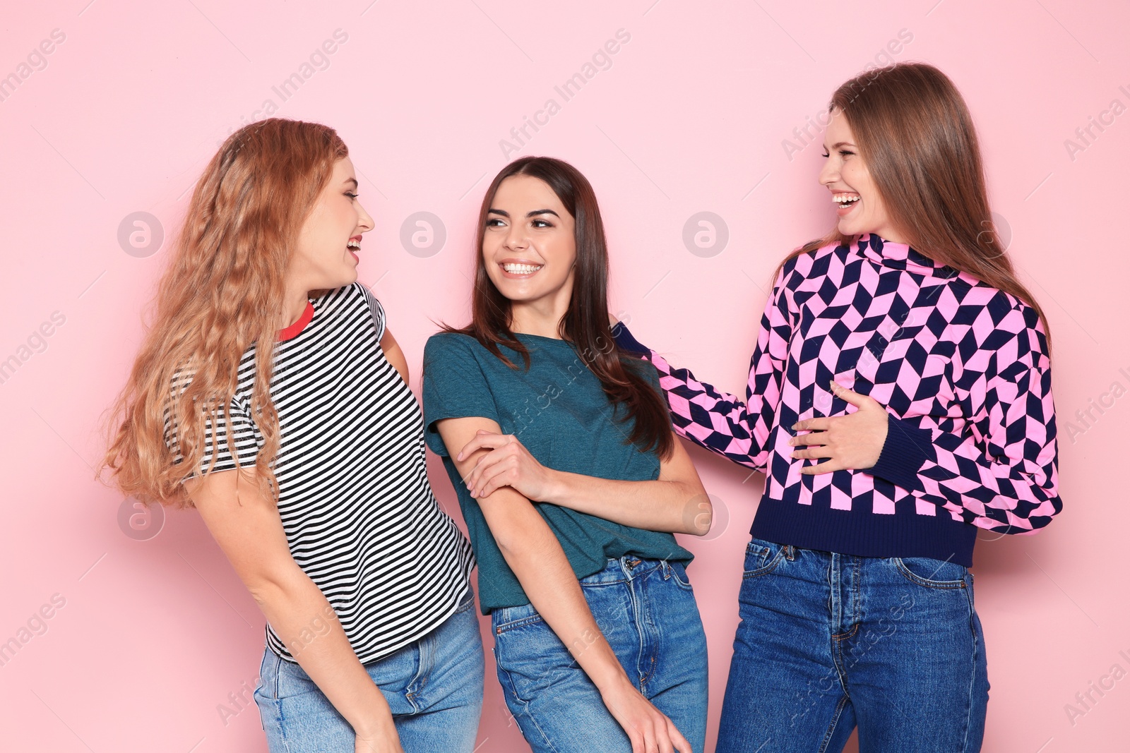 Photo of Portrait of young women laughing on color background