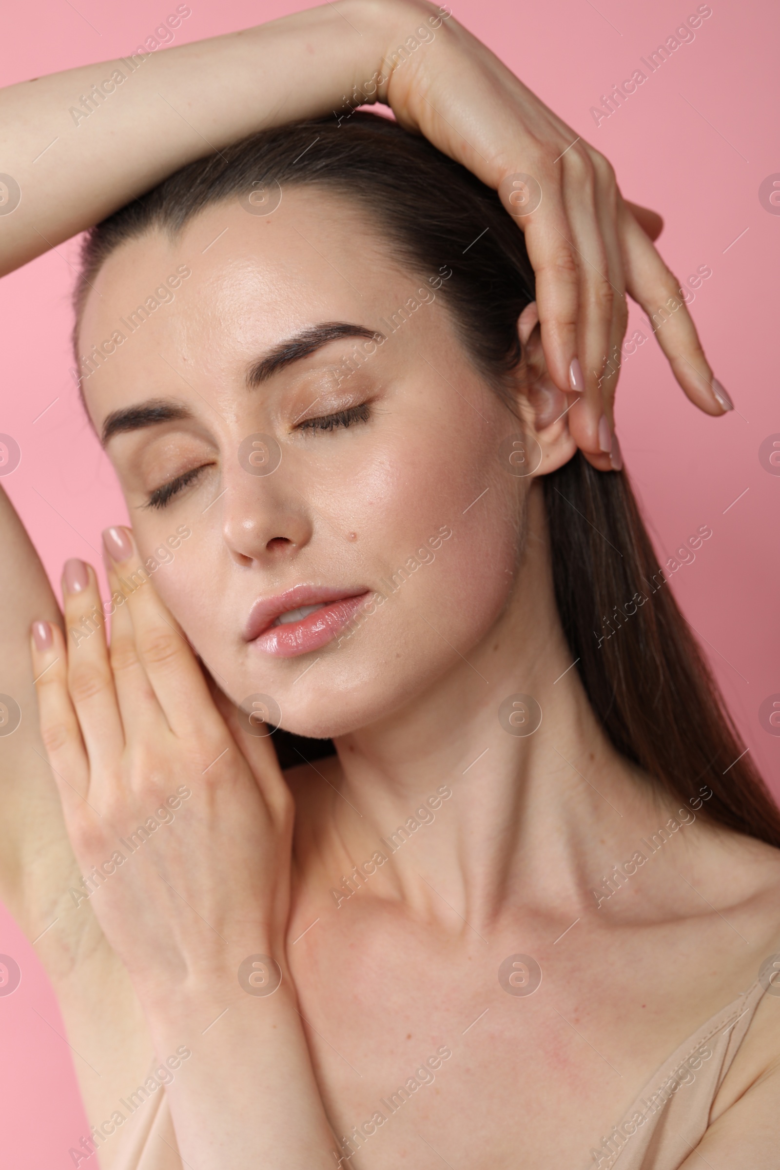 Photo of Portrait of beautiful young woman on pink background