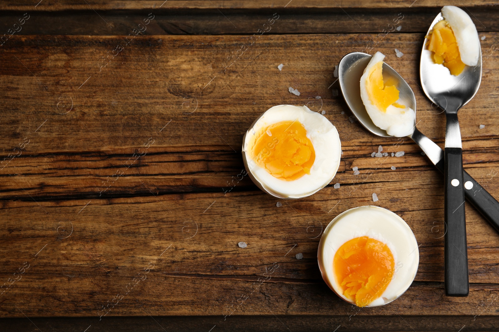 Photo of Tasty boiled chicken eggs on wooden table, flat lay. Space for text