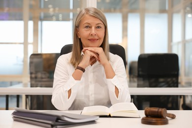Portrait of confident lawyer working at table in office