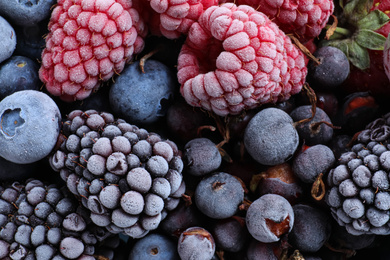 Photo of Mix of different frozen berries as background, top view