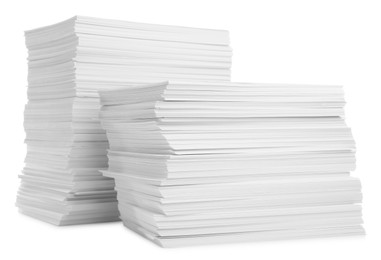 Photo of Stacks of paper sheets isolated on white