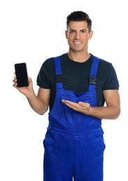 Repairman with modern smartphone on white background