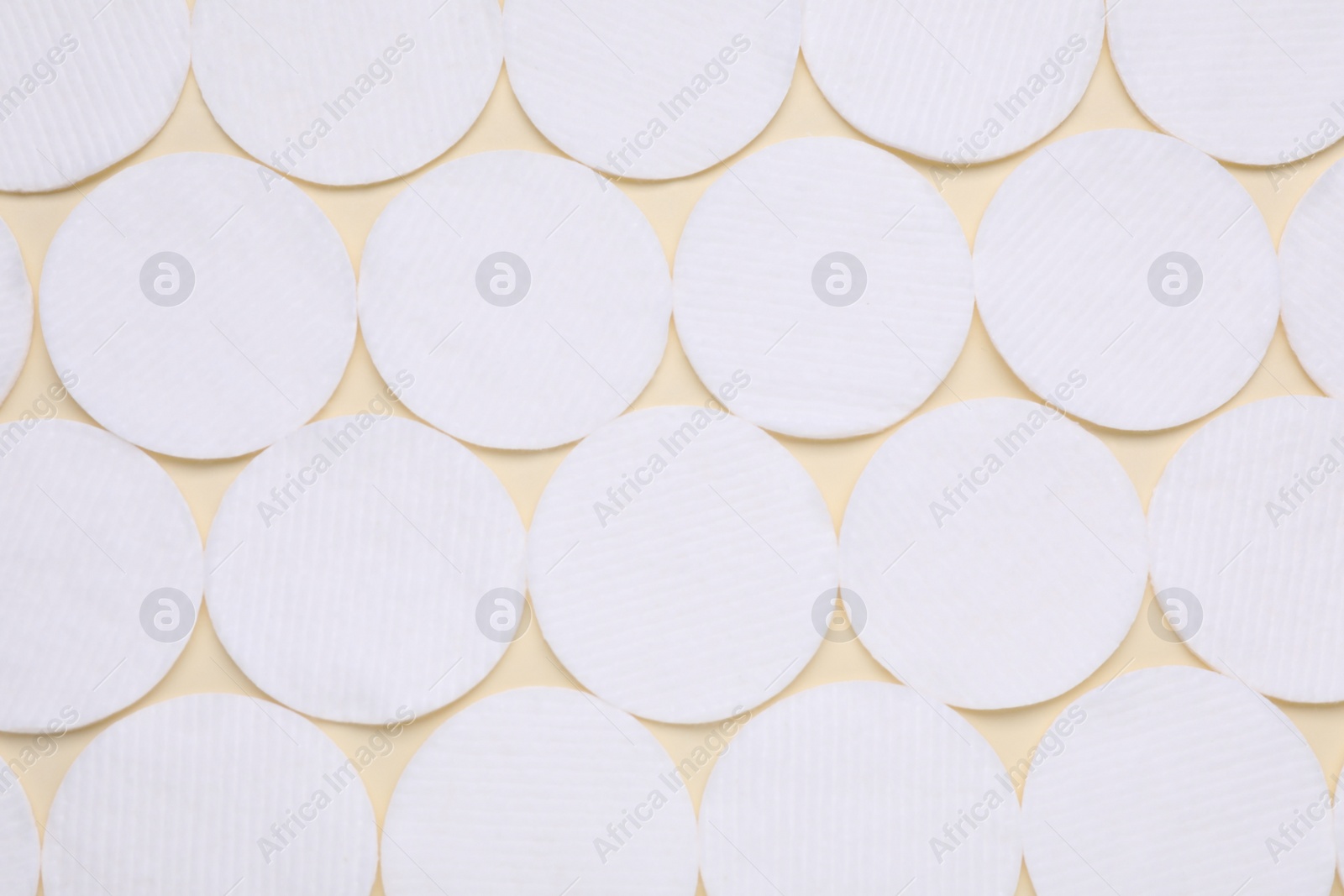 Photo of Many clean cotton pads on yellow background, flat lay