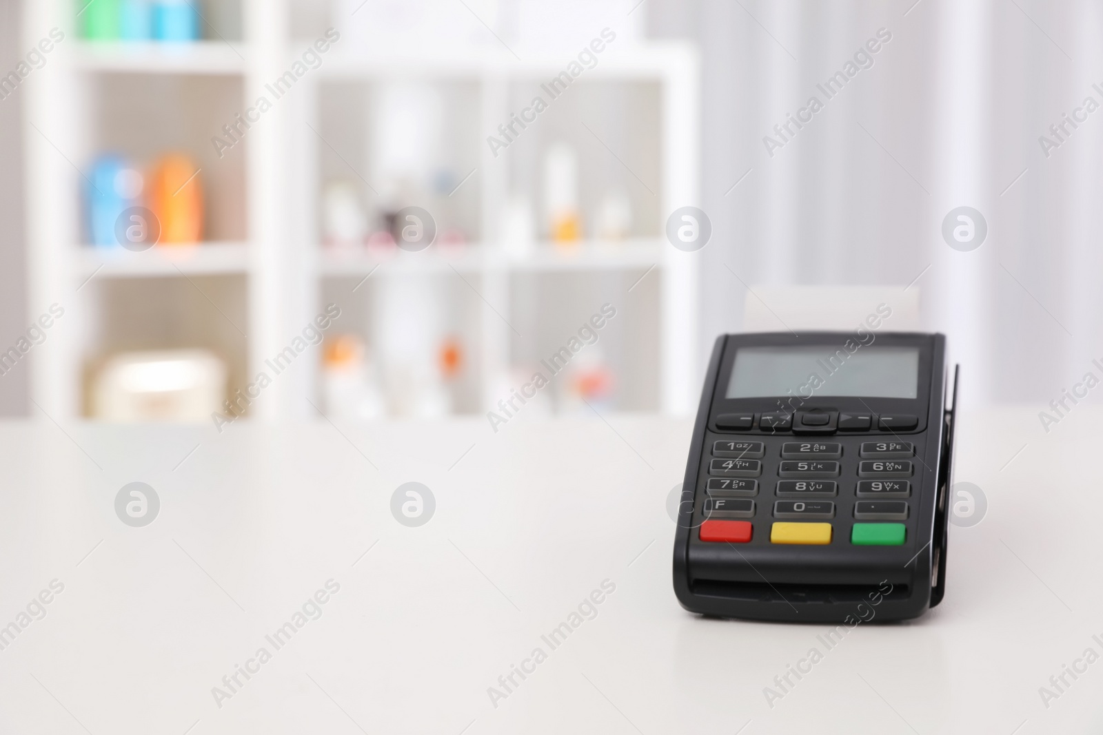Photo of Payment terminal on counter in pharmacy. Space for text