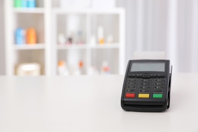 Payment terminal on counter in pharmacy. Space for text