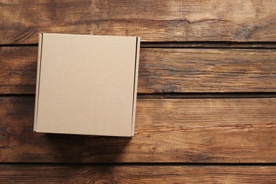 Cardboard box on wooden background