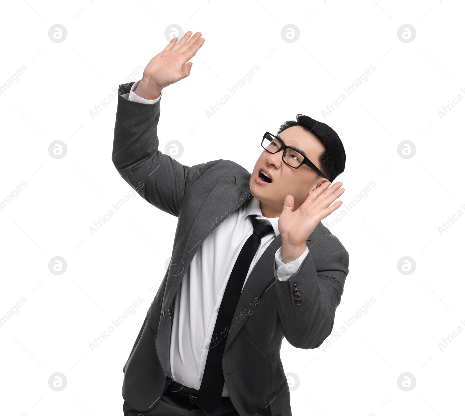 Photo of Scared businessman in suit posing on white background