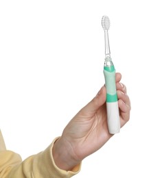 Photo of Woman holding electric toothbrush on white background, closeup