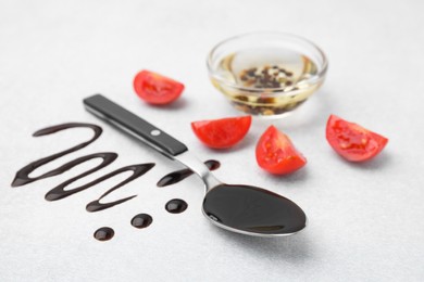 Photo of Organic balsamic vinegar and cooking ingredients on white table