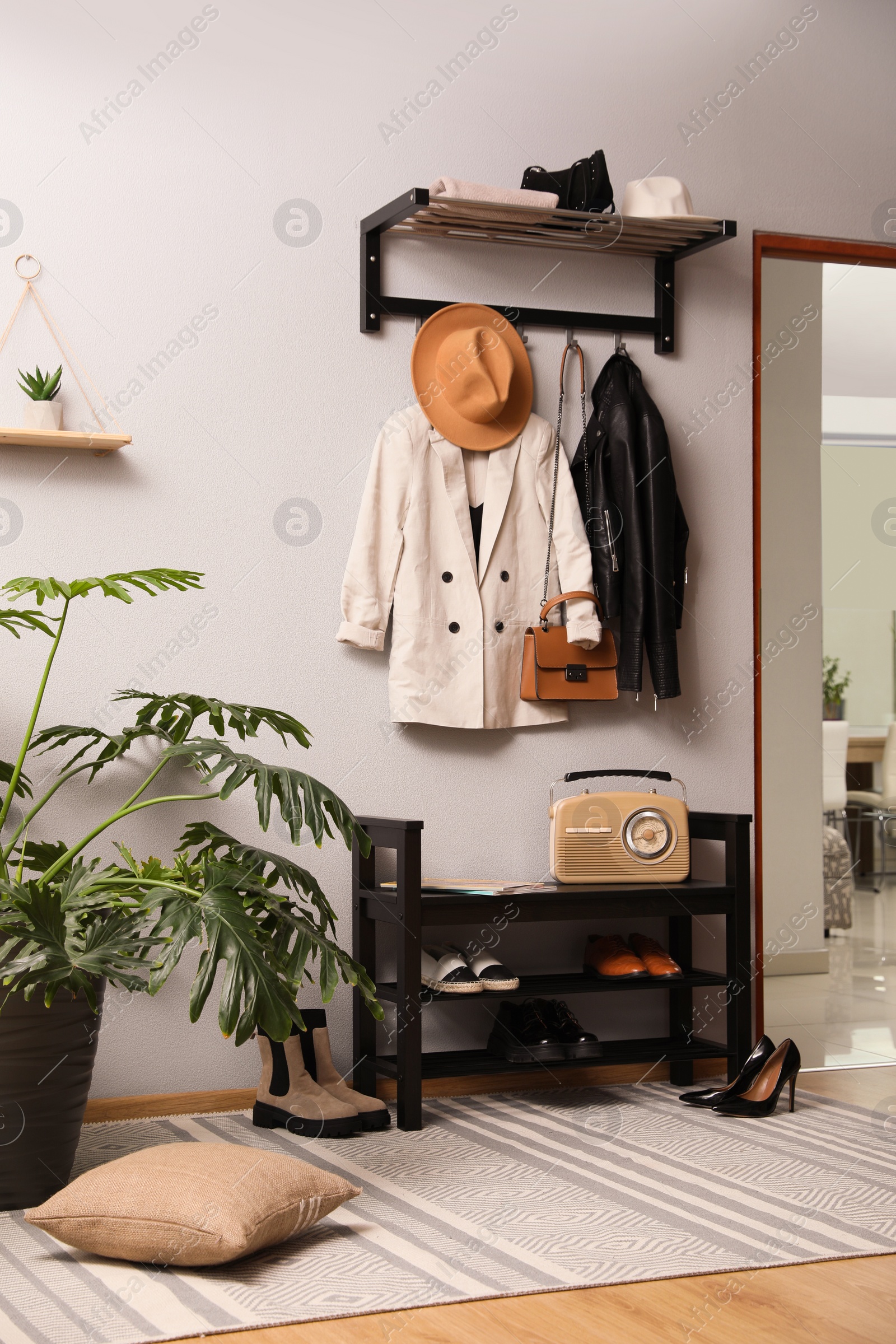 Photo of Hallway interior with stylish furniture, clothes and accessories