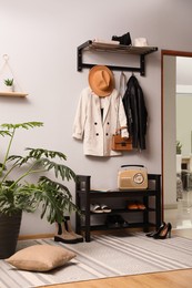 Hallway interior with stylish furniture, clothes and accessories