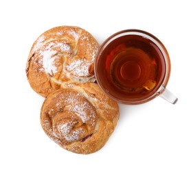 Photo of Delicious rolls with jam, powdered sugar and cup of tea isolated on white, top view. Sweet buns