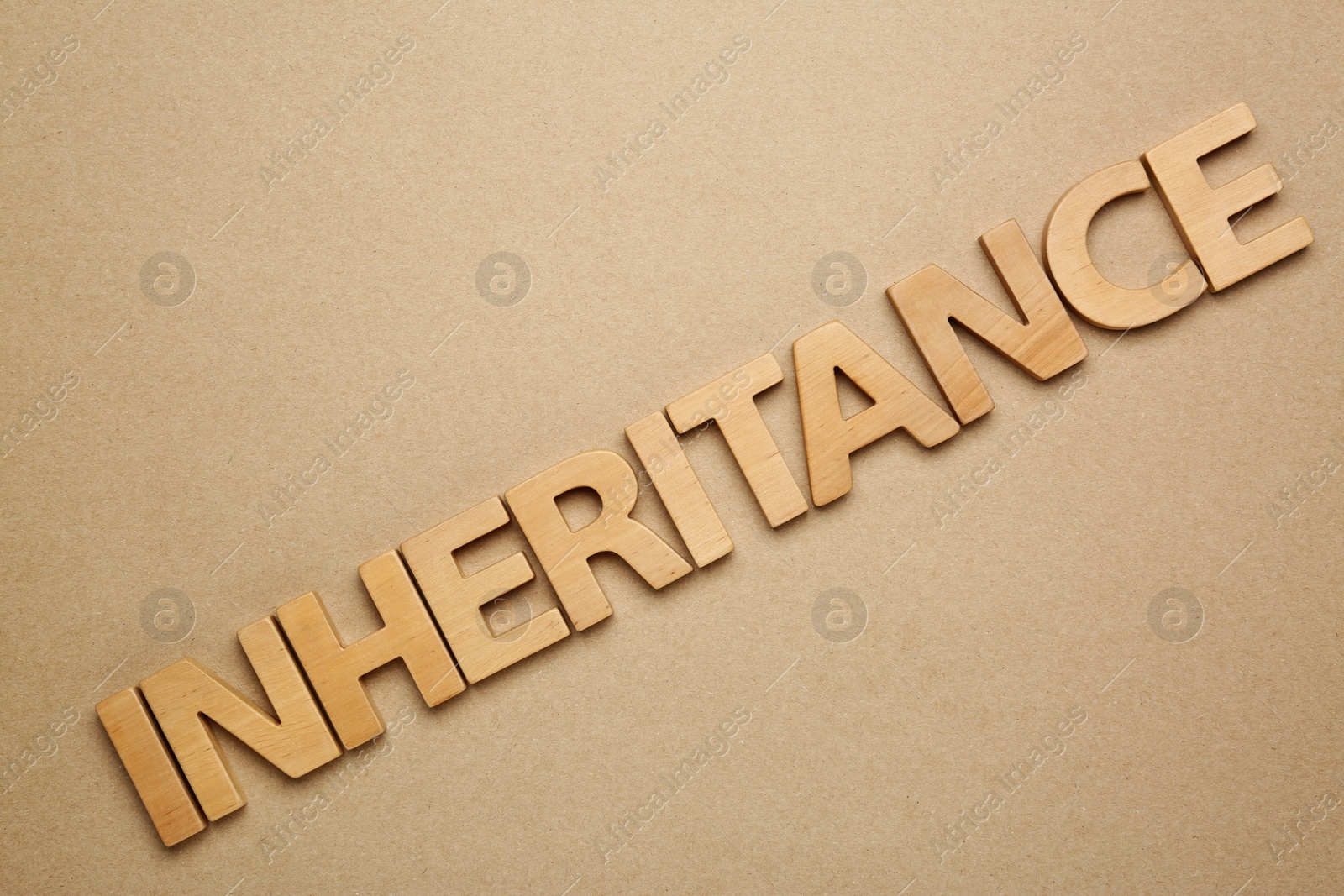 Photo of Word Inheritance made with wooden letters on beige background, flat lay