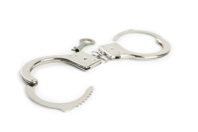 Photo of Classic chain handcuffs with key on white background