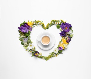 Photo of Beautiful heart made of different flowers and coffee on white background, top view