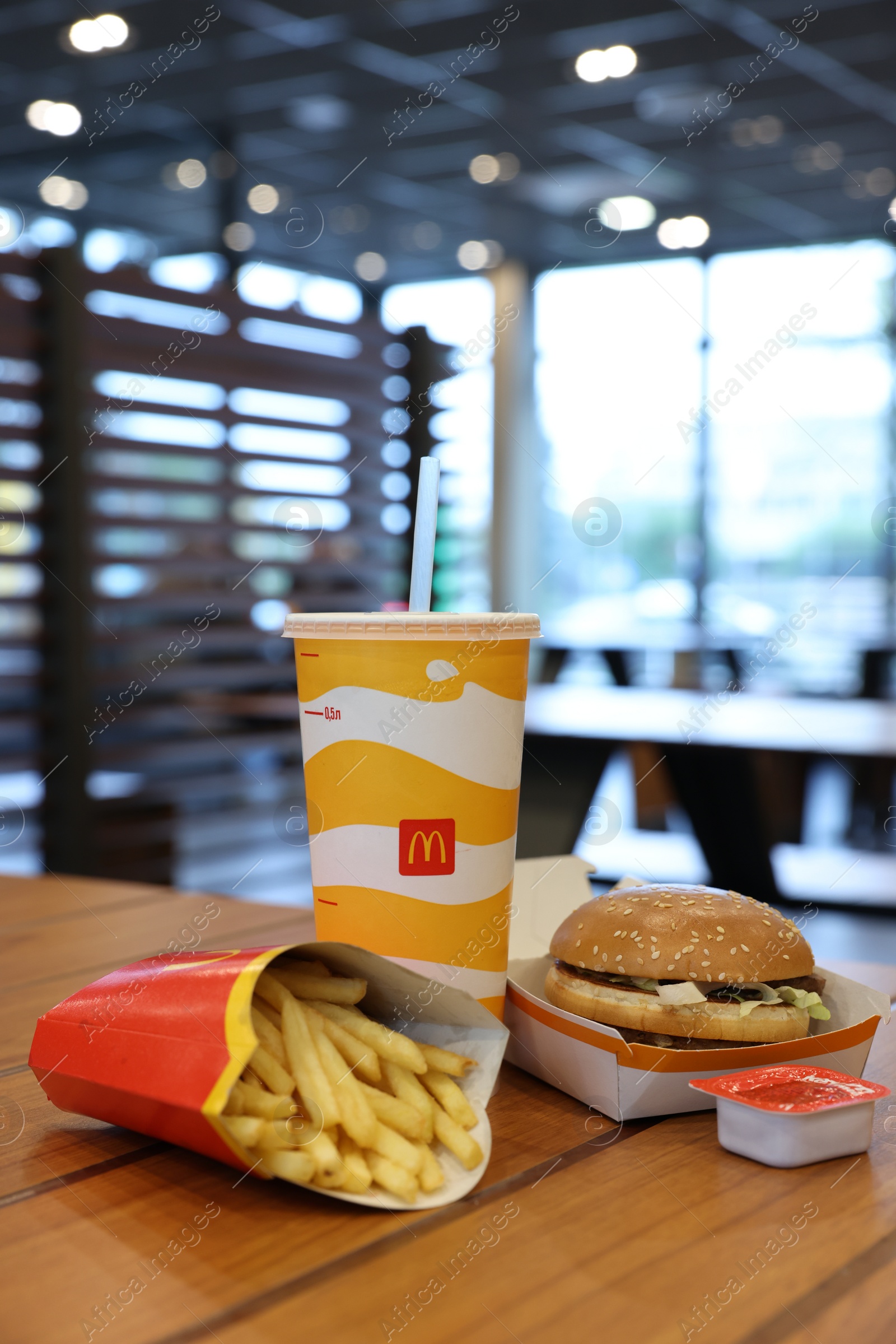 Photo of Lviv, Ukraine - October 9, 2023: McDonald's menu on wooden table in restaurant