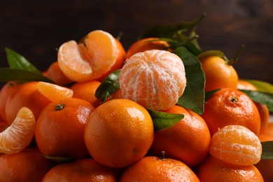 Photo of Fresh ripe juicy tangerines against blurred background, closeup