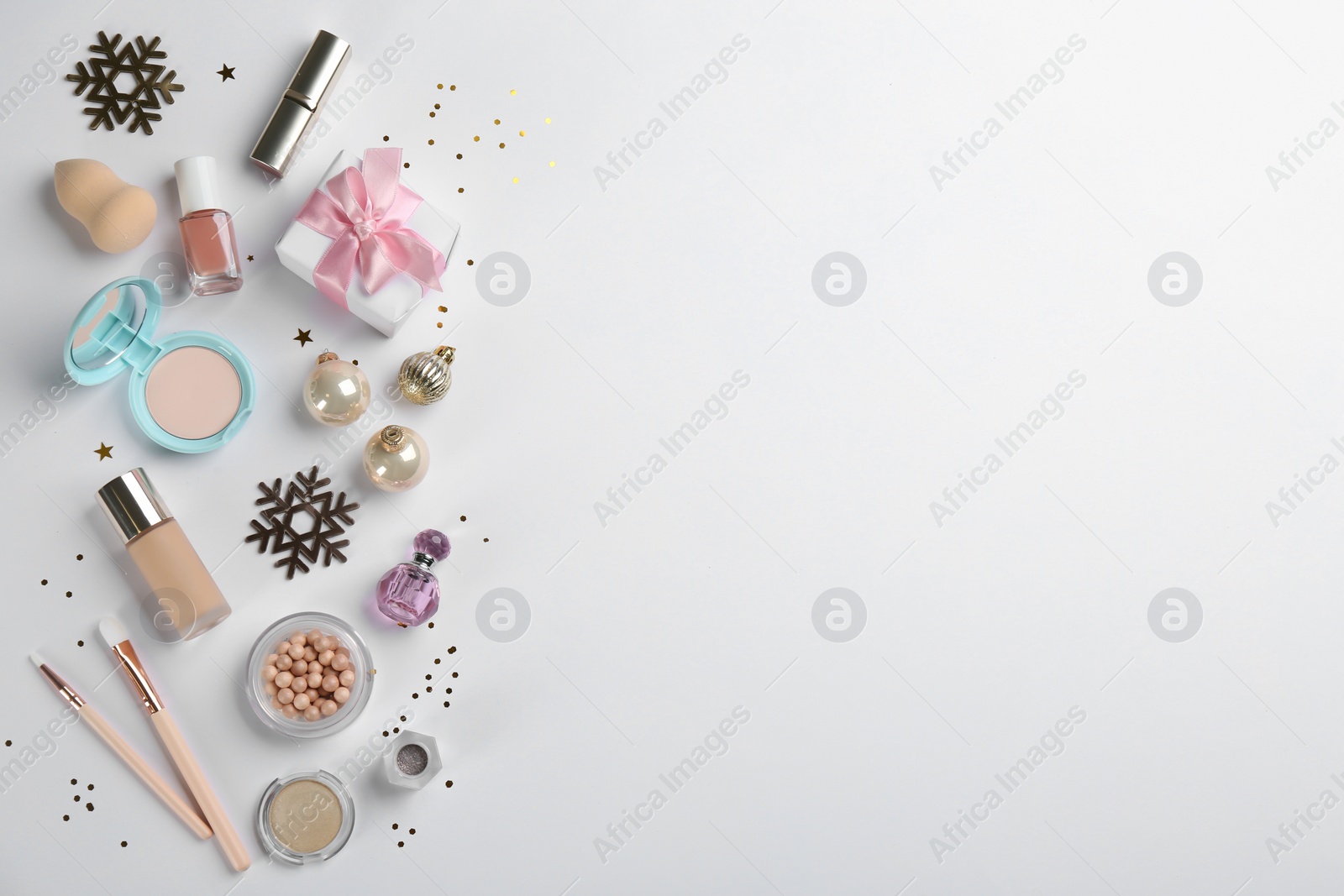 Photo of Flat lay composition with decorative cosmetic products on light background. Winter care. Space for text