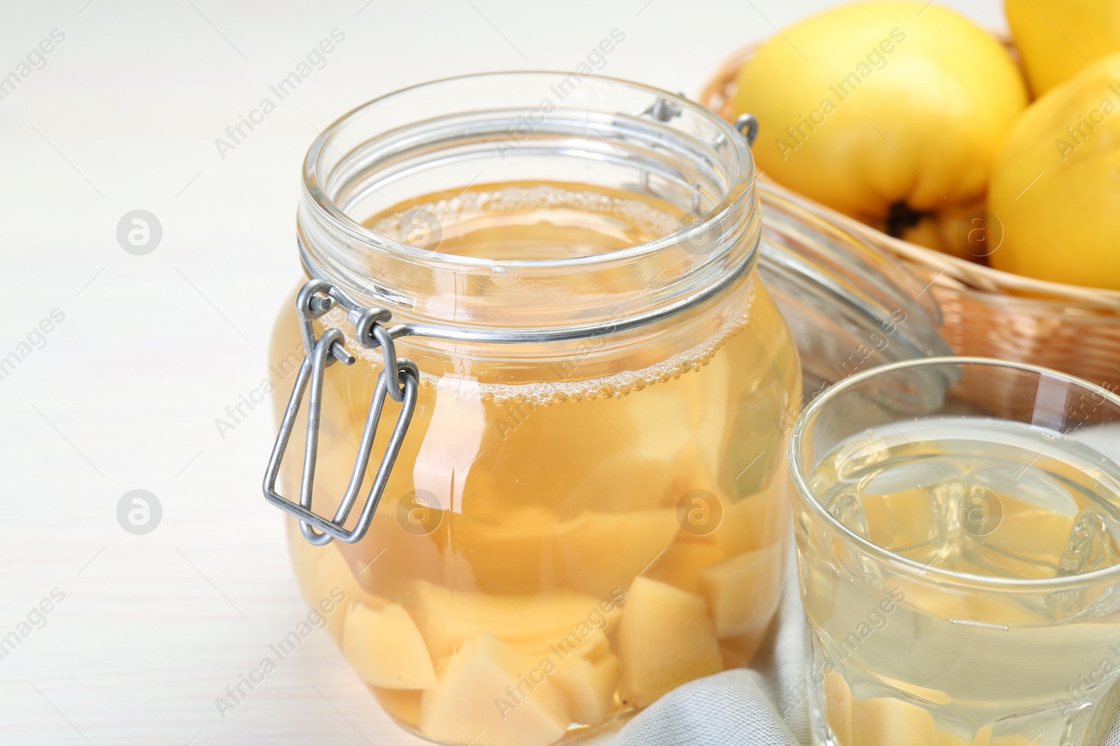 Photo of Delicious quince drink on white table, closeup