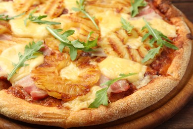 Photo of Delicious pineapple pizza with arugula on table, closeup