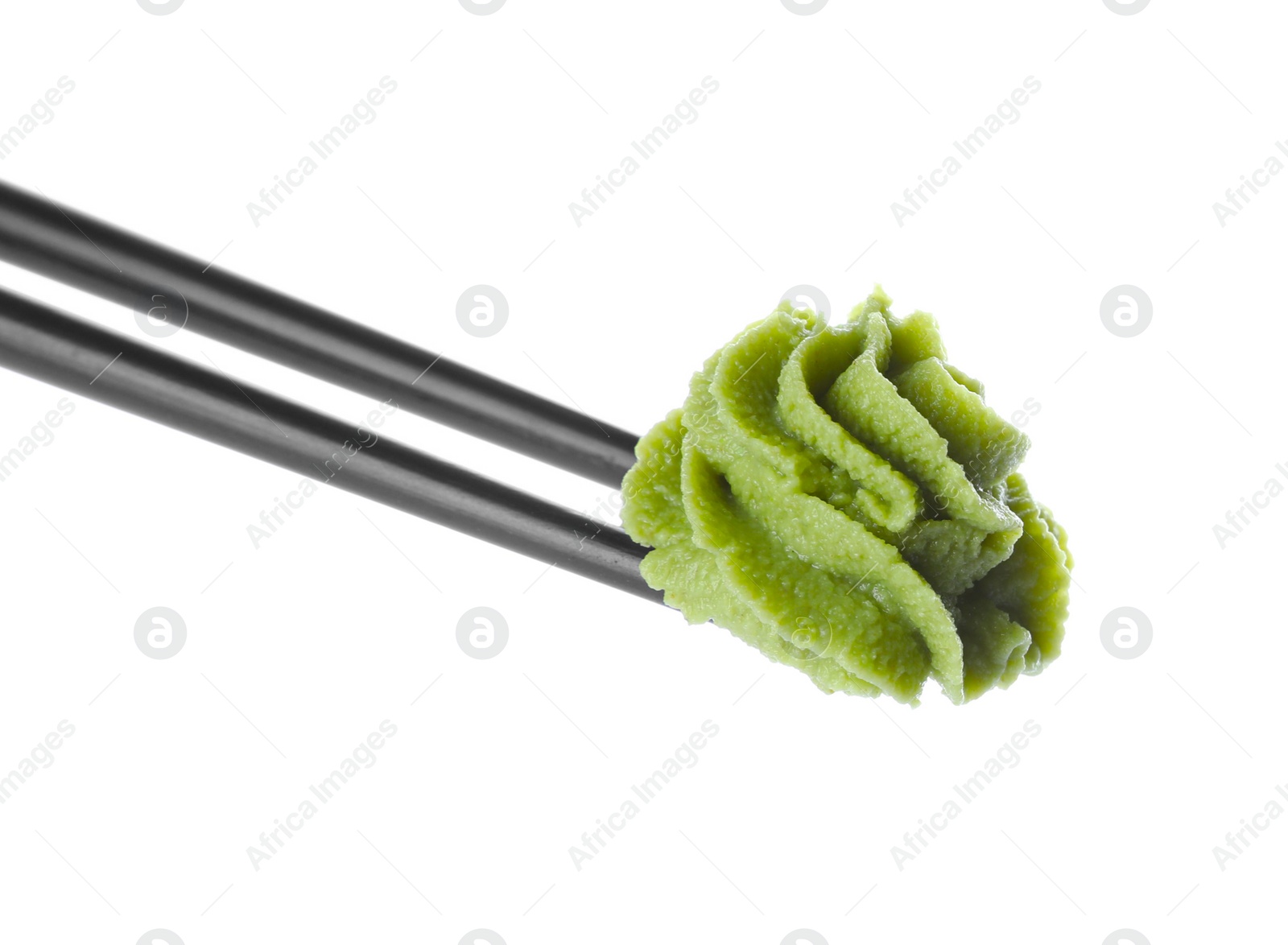 Photo of Chopsticks with swirl of wasabi paste isolated on white