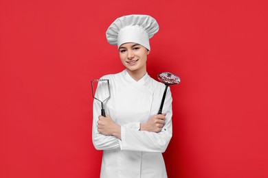 Photo of Professional chef with potato pusher and skimmer on red background