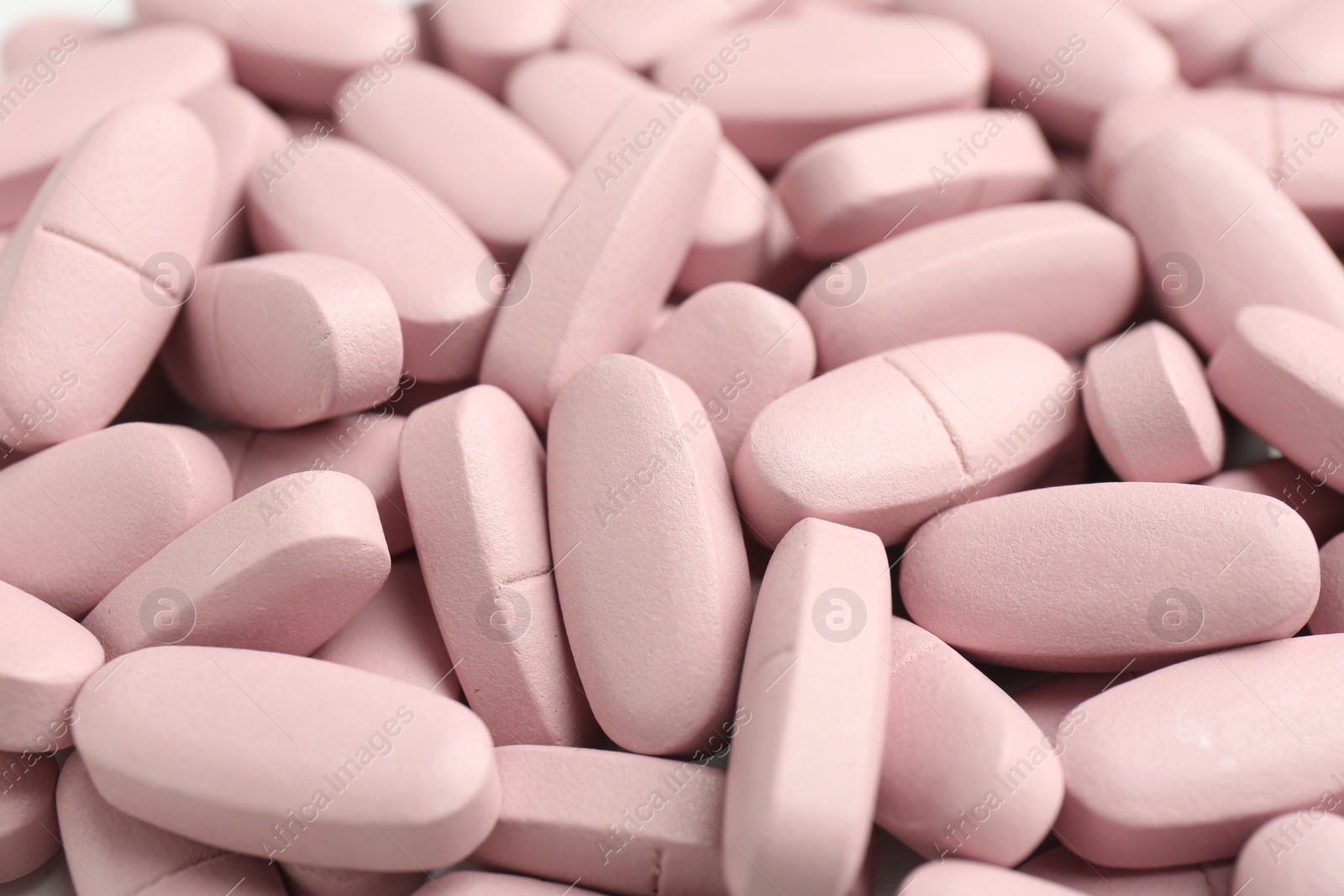 Photo of Many pink vitamin capsules as background, closeup