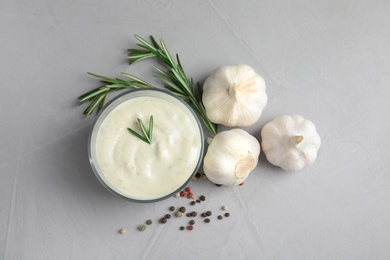 Photo of Flat lay composition with garlic sauce on grey background