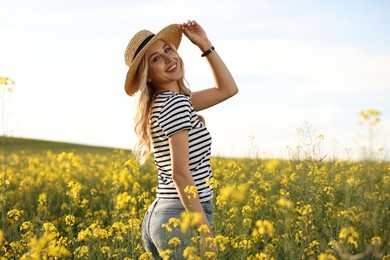 Photo of Happy young woman with straw hat in field on spring day