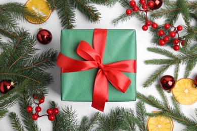 Photo of Composition with green gift box and Christmas decor on white background, flat lay