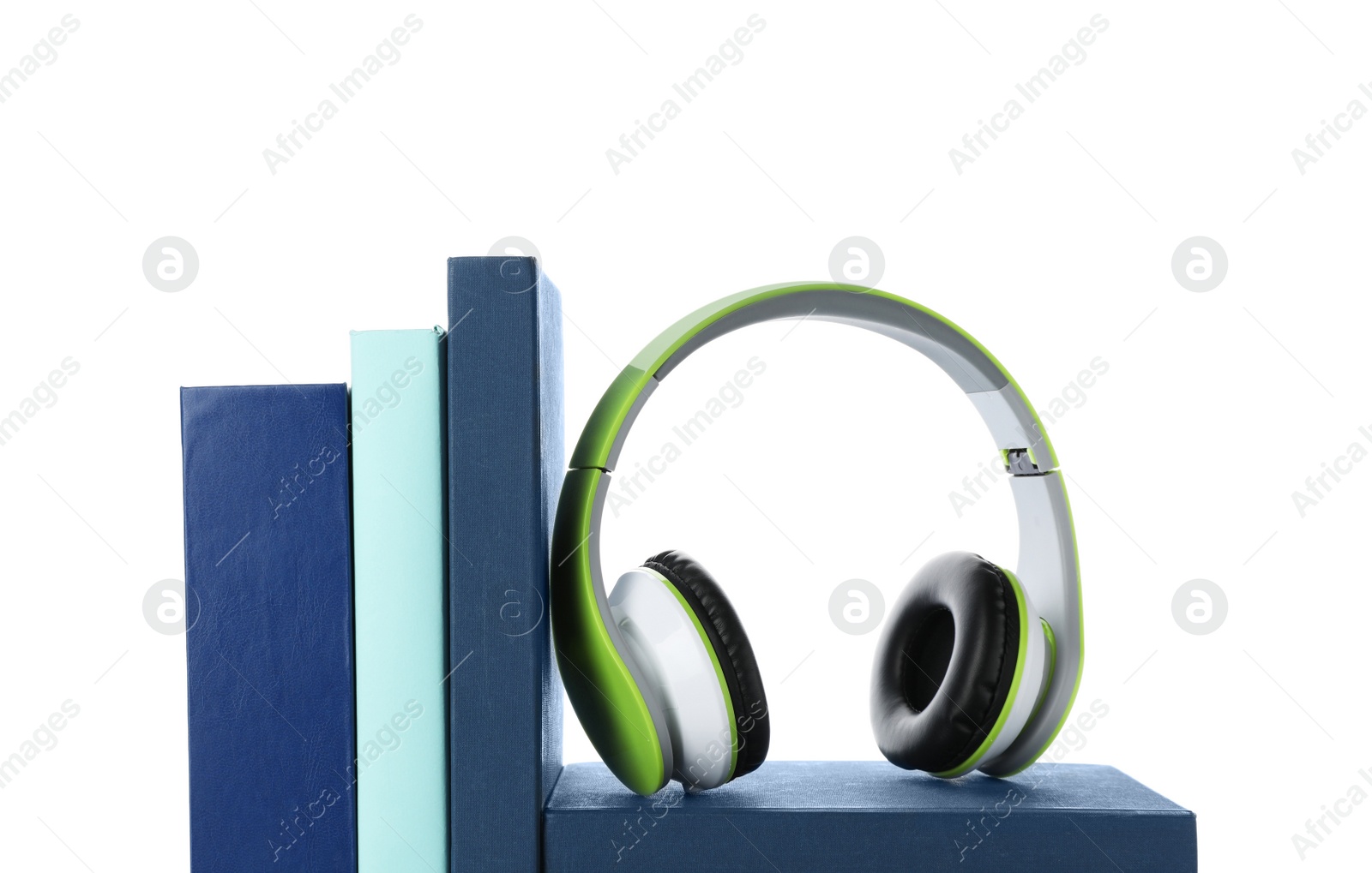 Photo of Modern headphones with hardcover books on white background