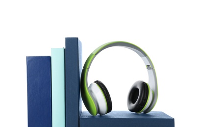 Photo of Modern headphones with hardcover books on white background