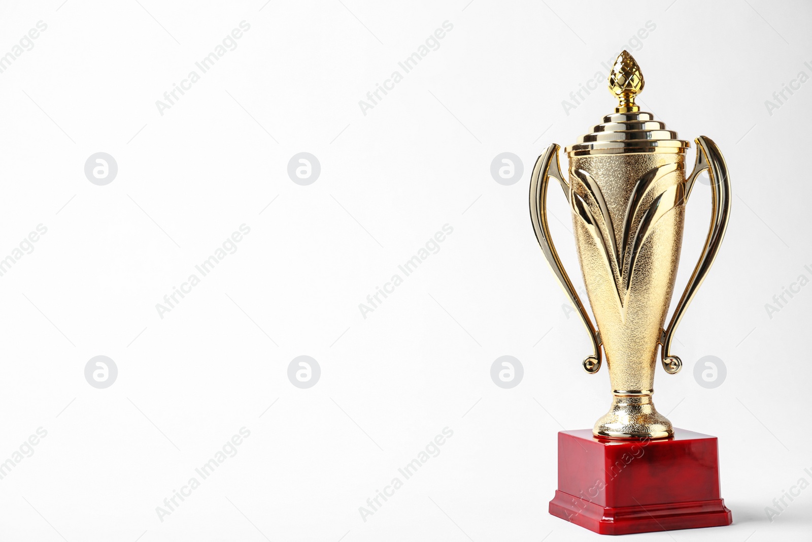 Photo of Shiny golden trophy cup on white background