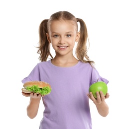 Happy girl holding sandwich and apple on white background. Healthy food for school lunch