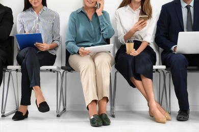 People waiting for job interview in office, closeup