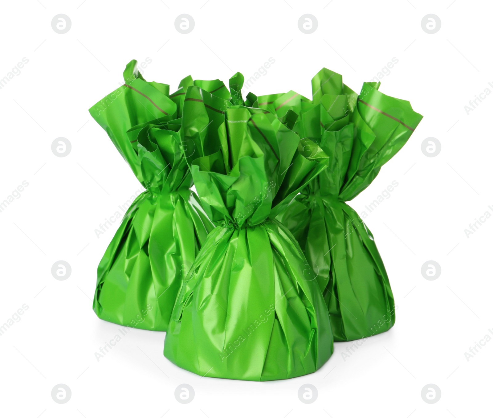 Photo of Delicious candies in green wrappers on white background