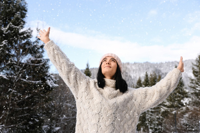 Beautiful young woman enjoying vacation on winter day