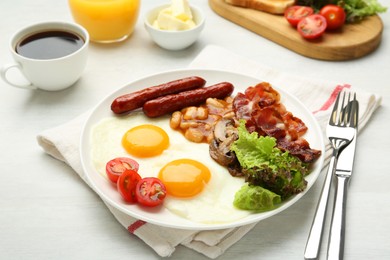 Delicious breakfast with sunny side up eggs served on white table