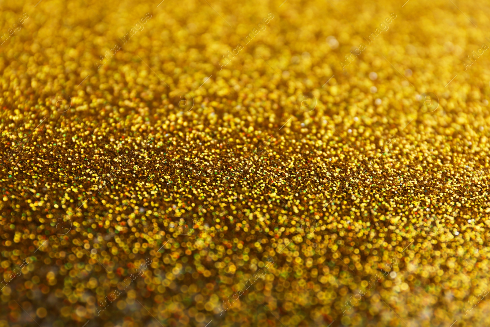 Photo of Closeup view of sparkling golden glitter background