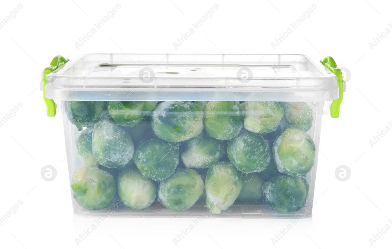 Photo of Plastic container with frozen brussel sprouts on white background. Vegetable preservation