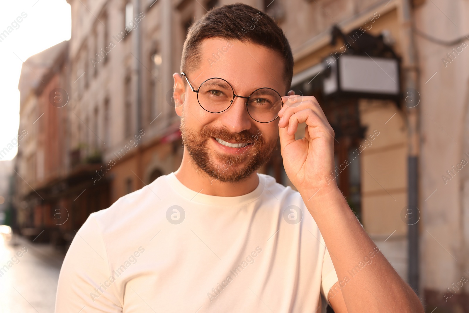 Photo of Portrait of handsome bearded man in glasses outdoors