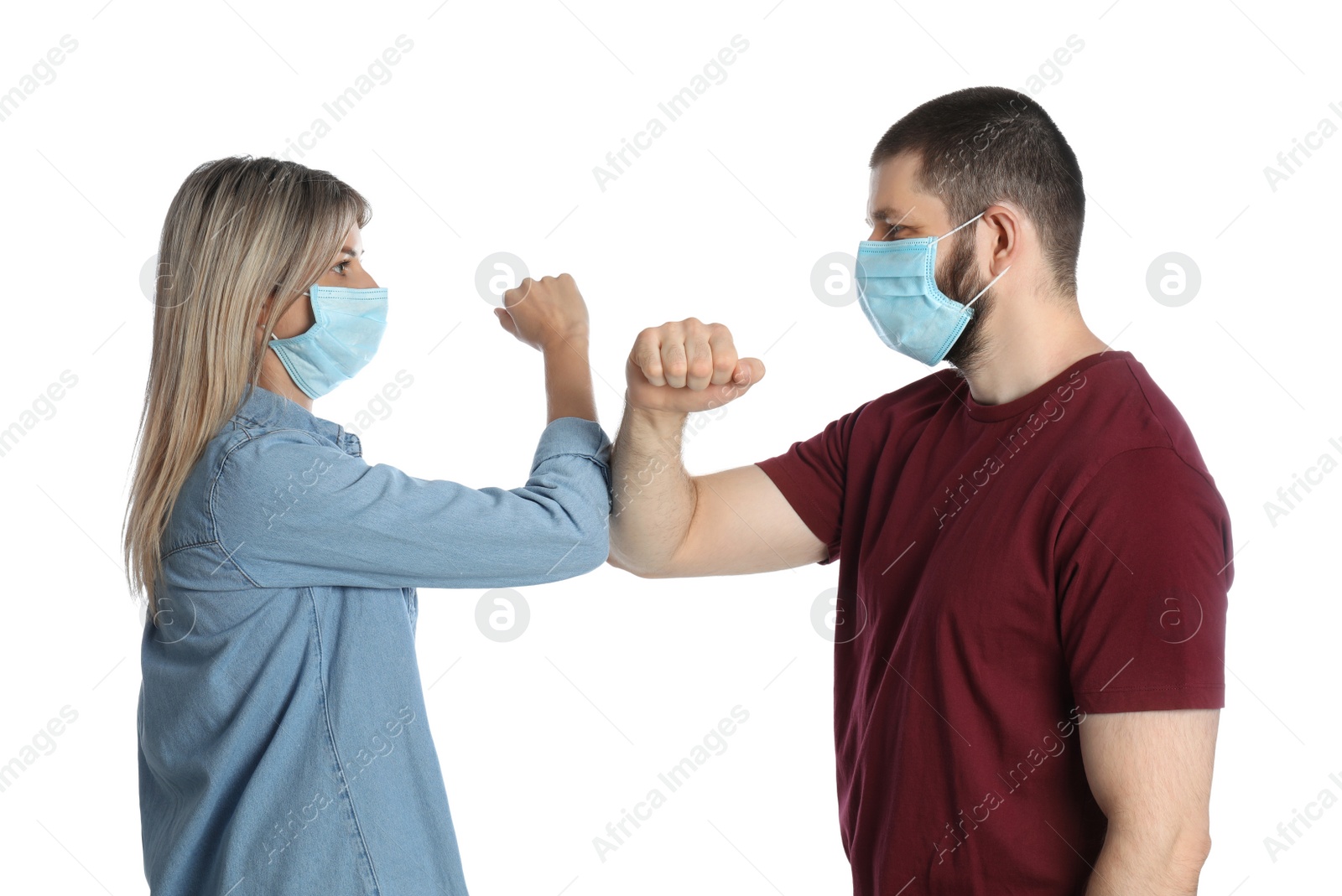 Photo of Man and woman bumping elbows to say hello on white background. Keeping social distance during coronavirus pandemic