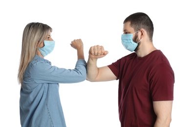 Photo of Man and woman bumping elbows to say hello on white background. Keeping social distance during coronavirus pandemic